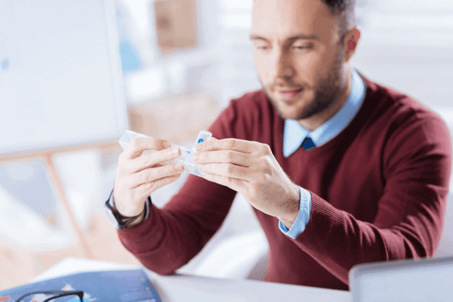 man holding a pillbox