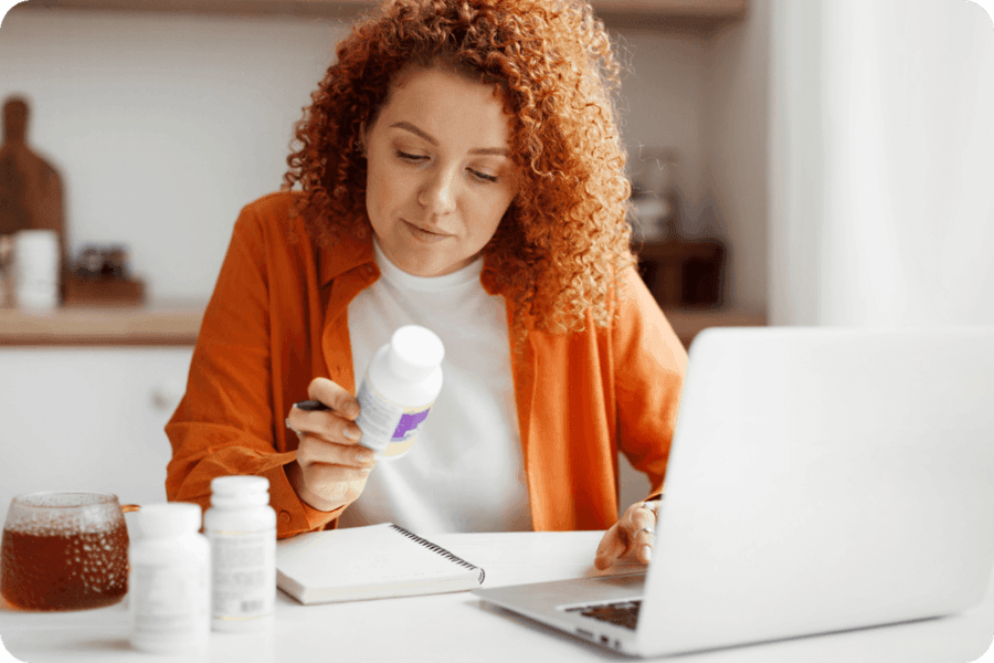 woman looking at a supplement label