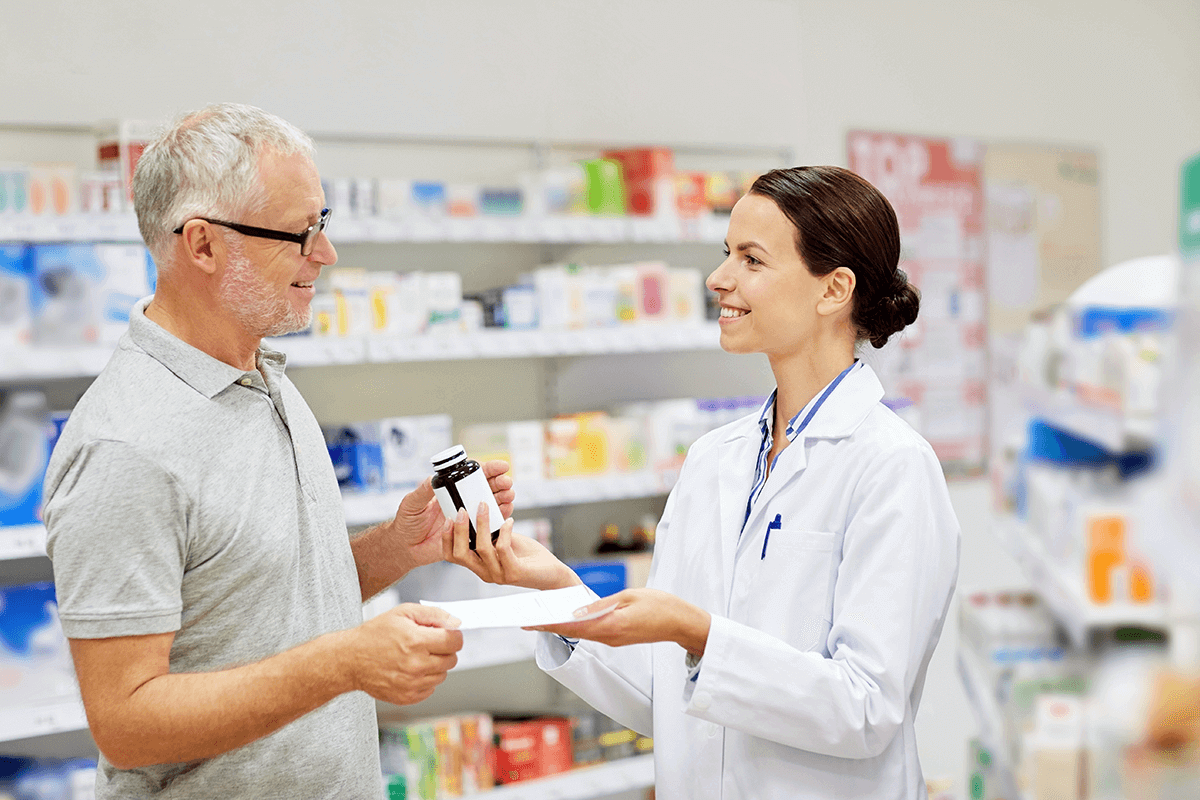 person talking to pharmacist in store
