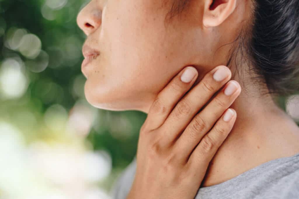 woman holding her neck