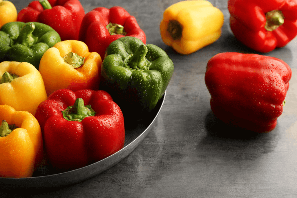 red, green, yellow peppers in a bowl all together