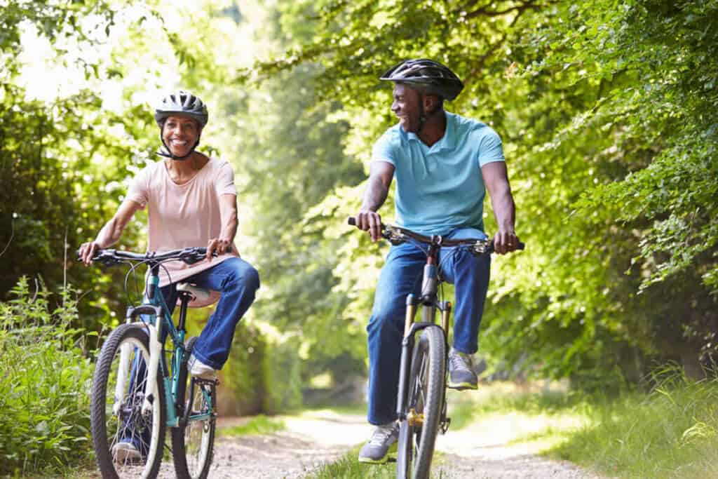 man and woman riding bikes outdoors