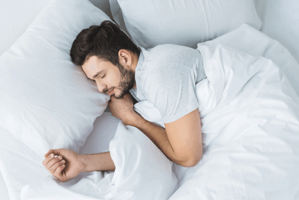 man sleeping in his bed
