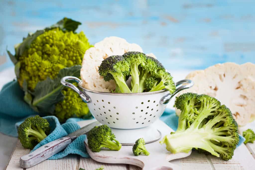 Broccoli and cauliflower in a white dish on a table