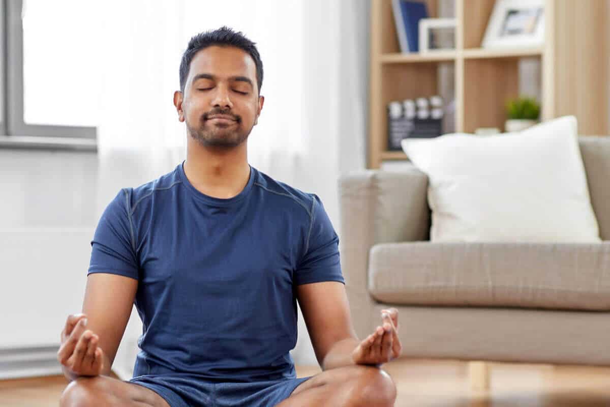 man sitting in a yoga position