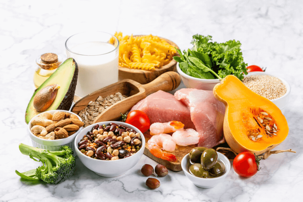 variety of foods on a table including fruits, seeds, vegetables