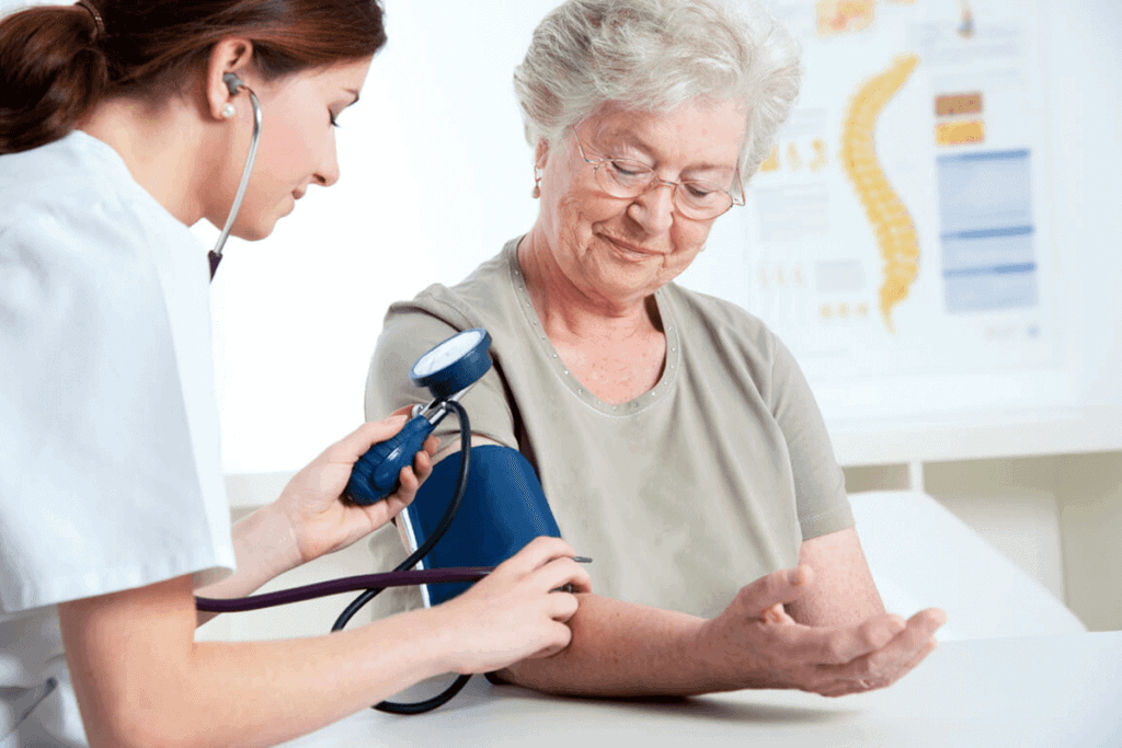 practitioner taking the blood pressure of a patient