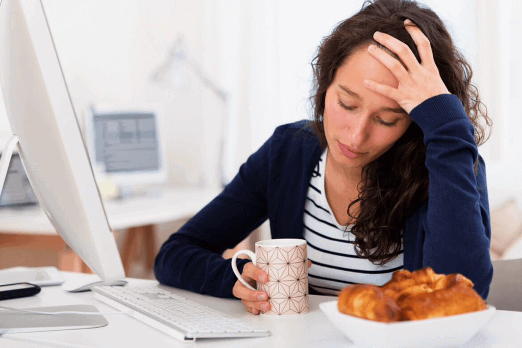 woman holding her head looking down