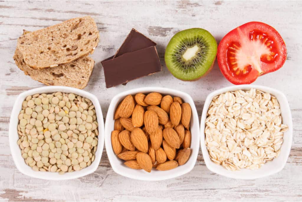 variety of nuts, vegetables and fruits in containers and on the table