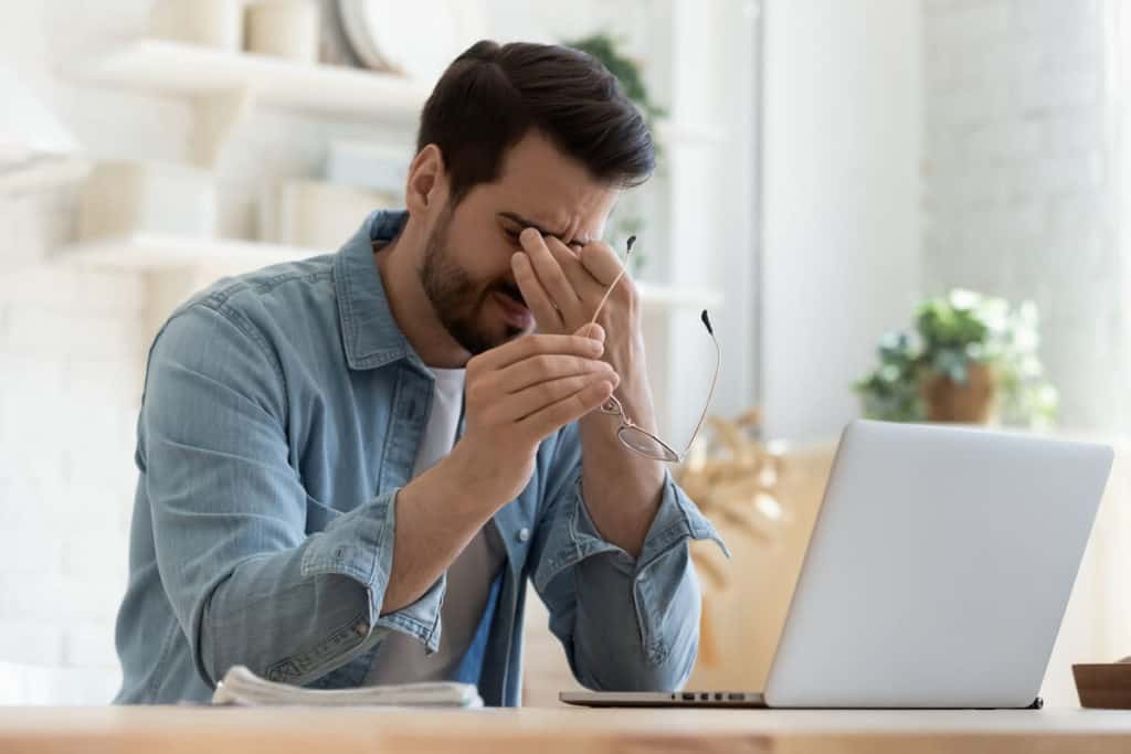 Image of man rubbing his eyes