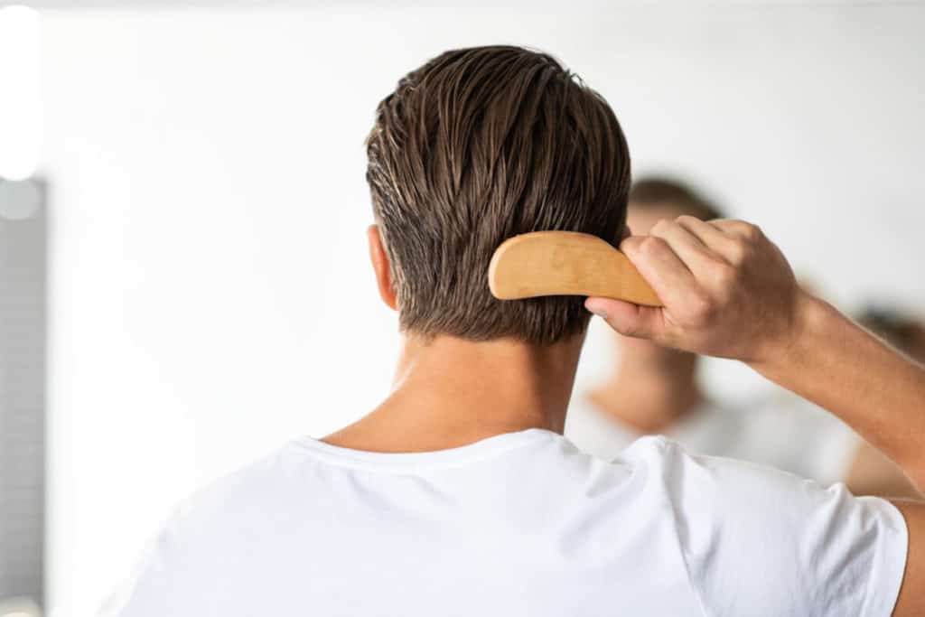 Image of man brushing his hair