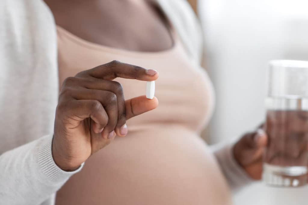 Woman holding a supplement