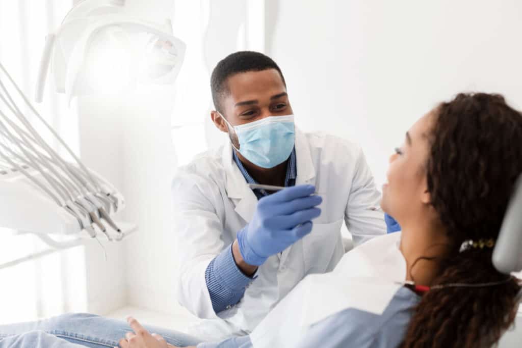 Dentist inspecting a patients teeth