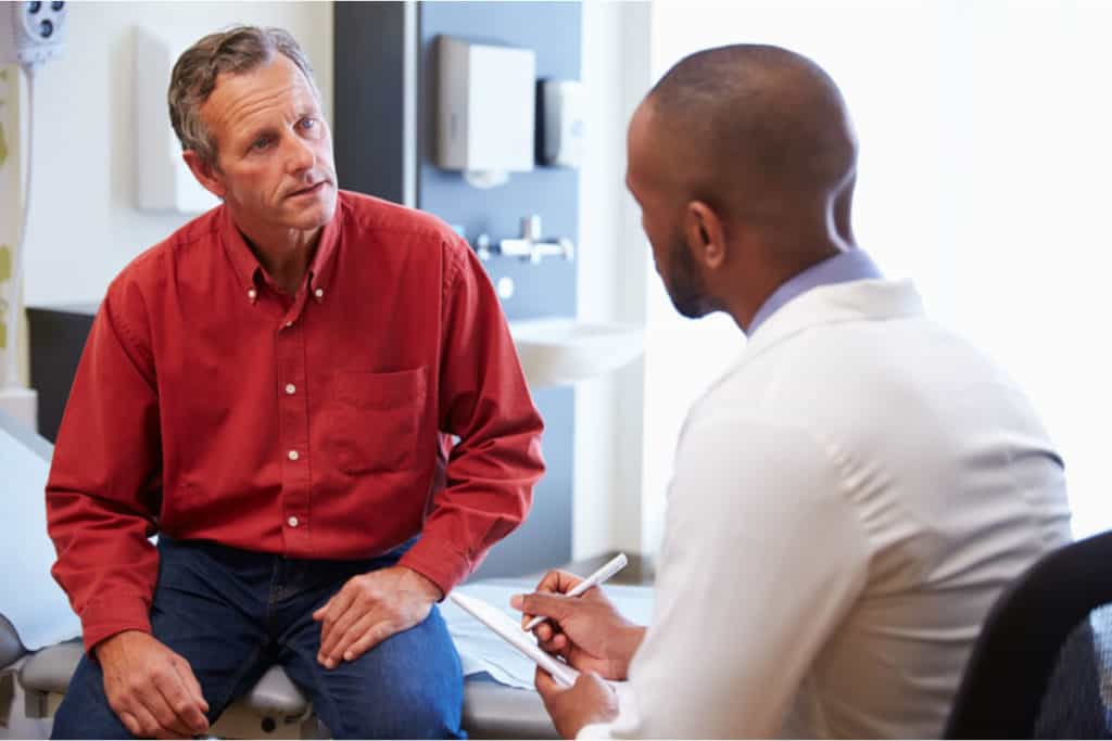man talking to health practitioner