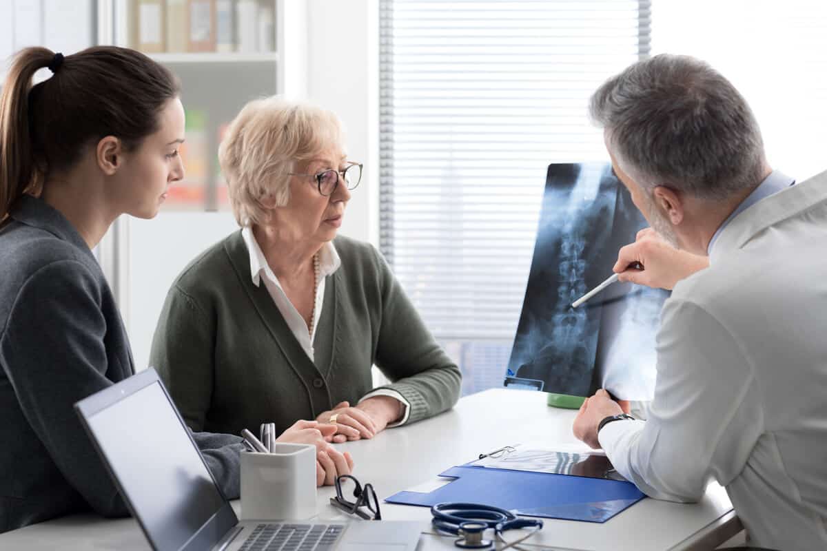 Practitioner showing patients an x-ray