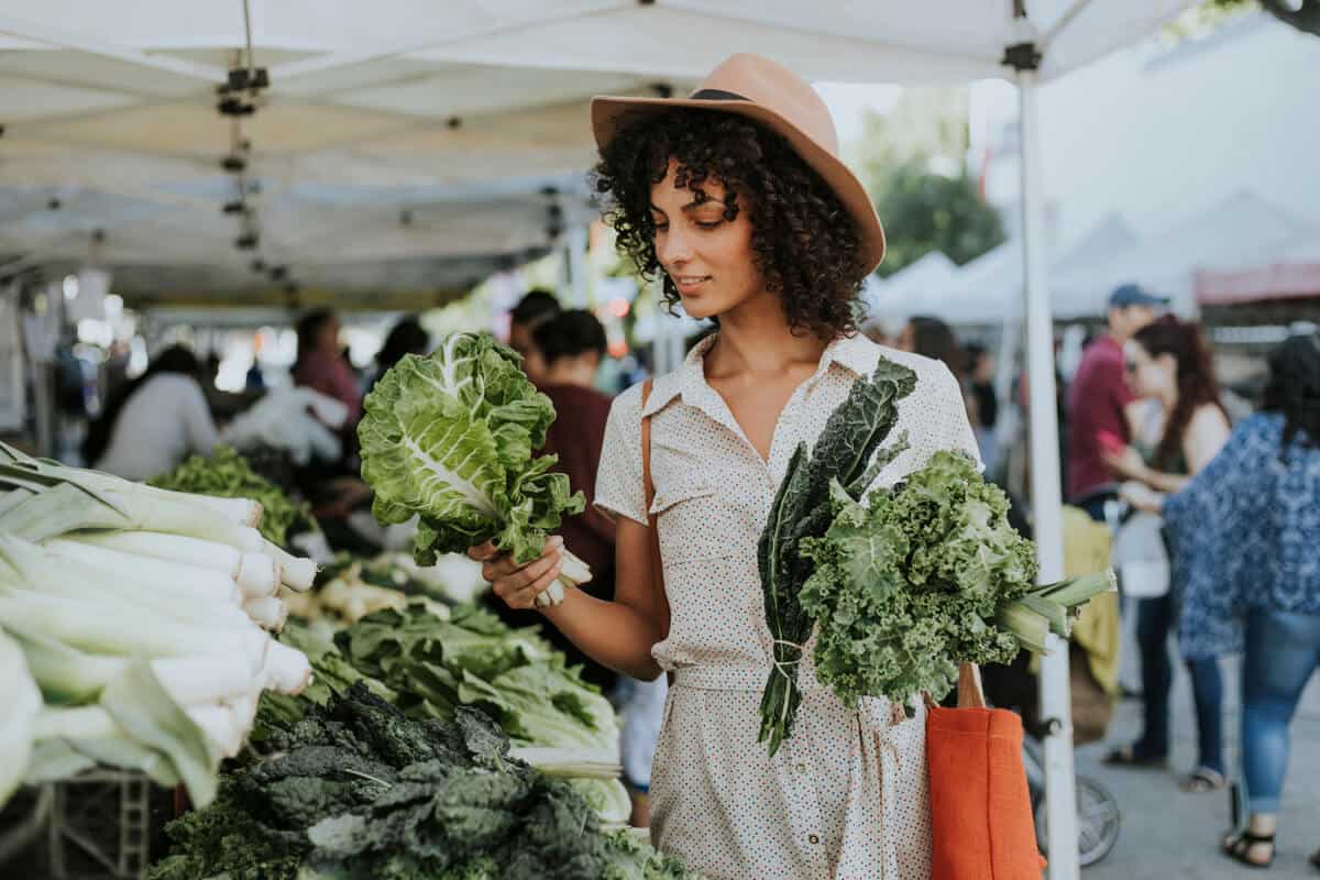 Woman picking vegetables at a farmers market