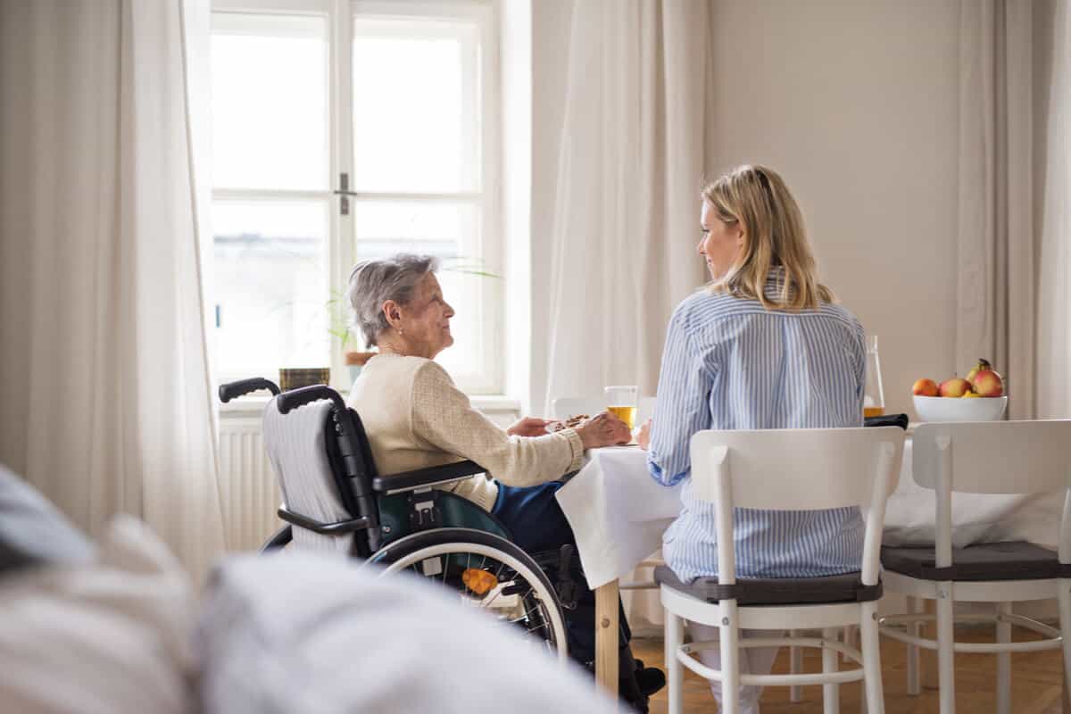 Woman caring for an elderly man