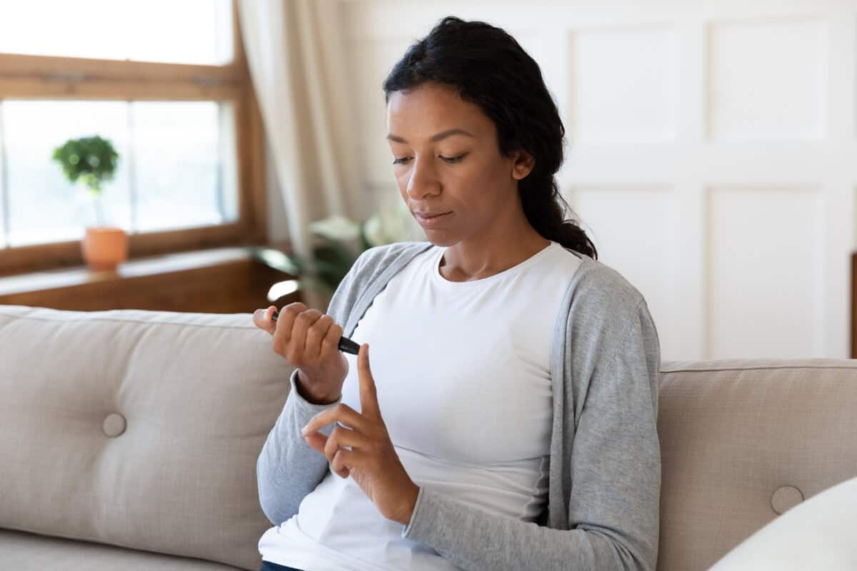 Woman testing her glucose levels