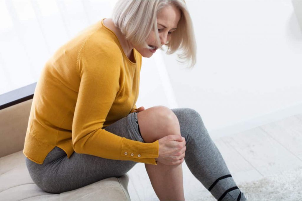 woman holding knee