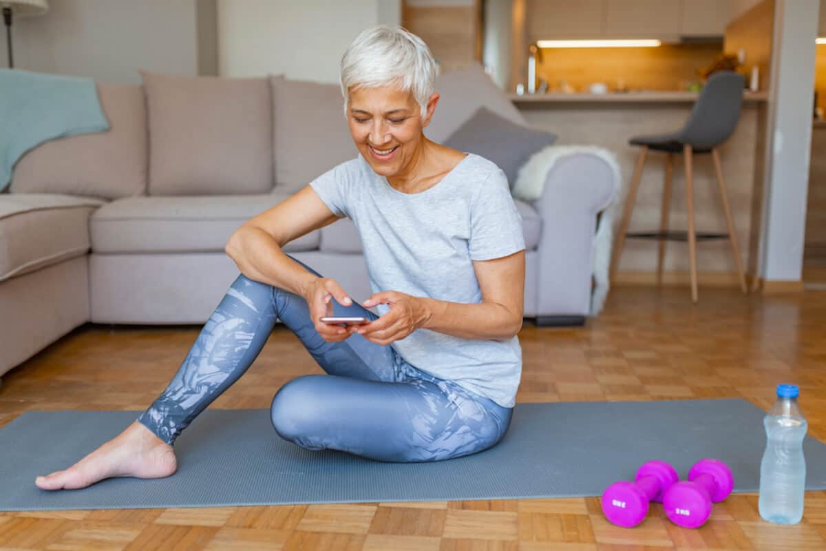 fitness tracking apps woman exercising in living room