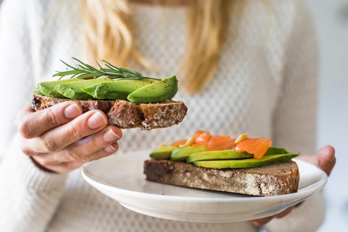 Woman holding avocado toast