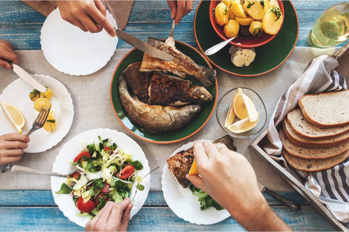 mediterranean diet table spread with mediterranean foods including salads and fish