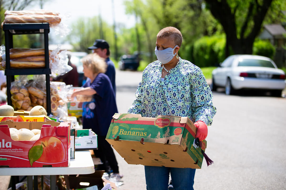 food vendor carrying boxes of produce