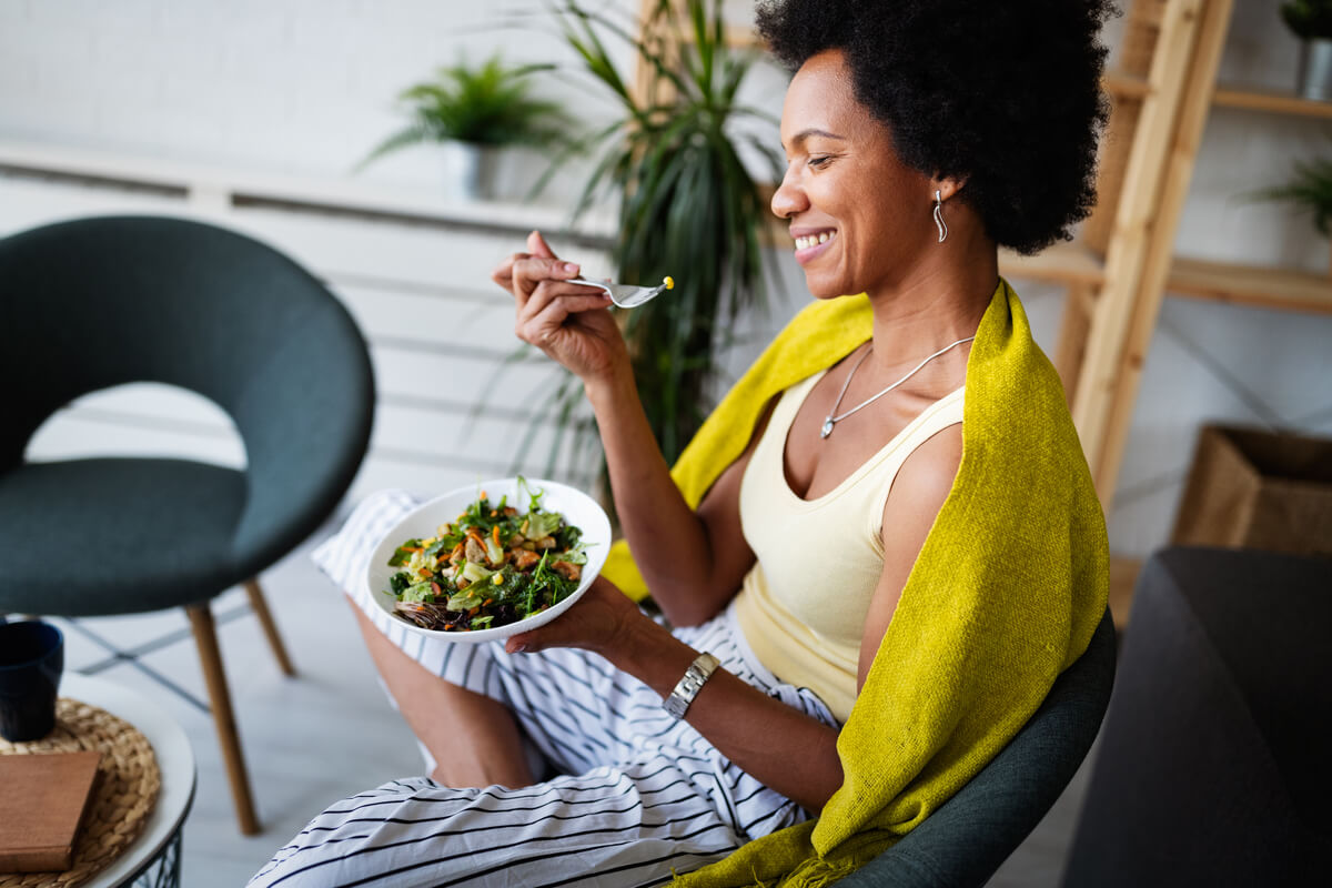 woman eating a bowl of salad