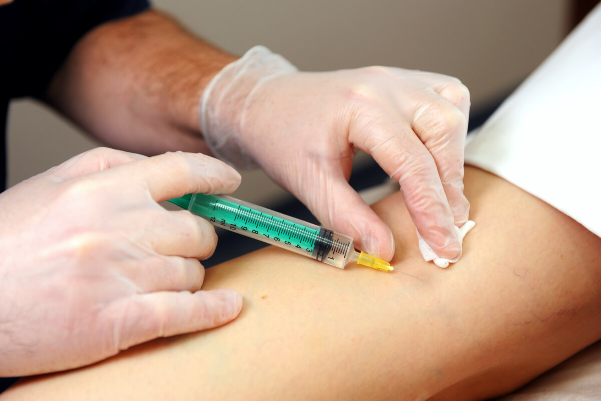 provider injecting patient with a syringe