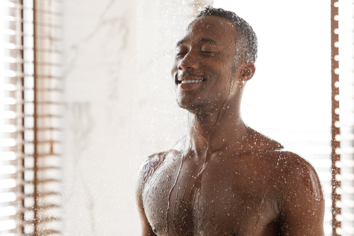 cold shower benefits man taking cold shower