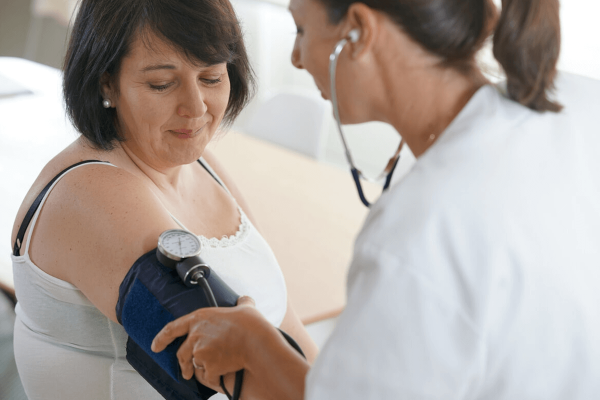 practitioner taking a patient's blood pressure