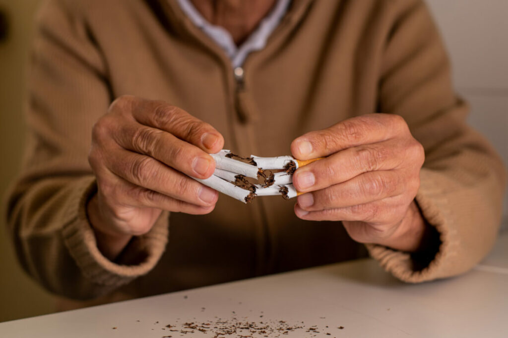breaking cigarette in hands
