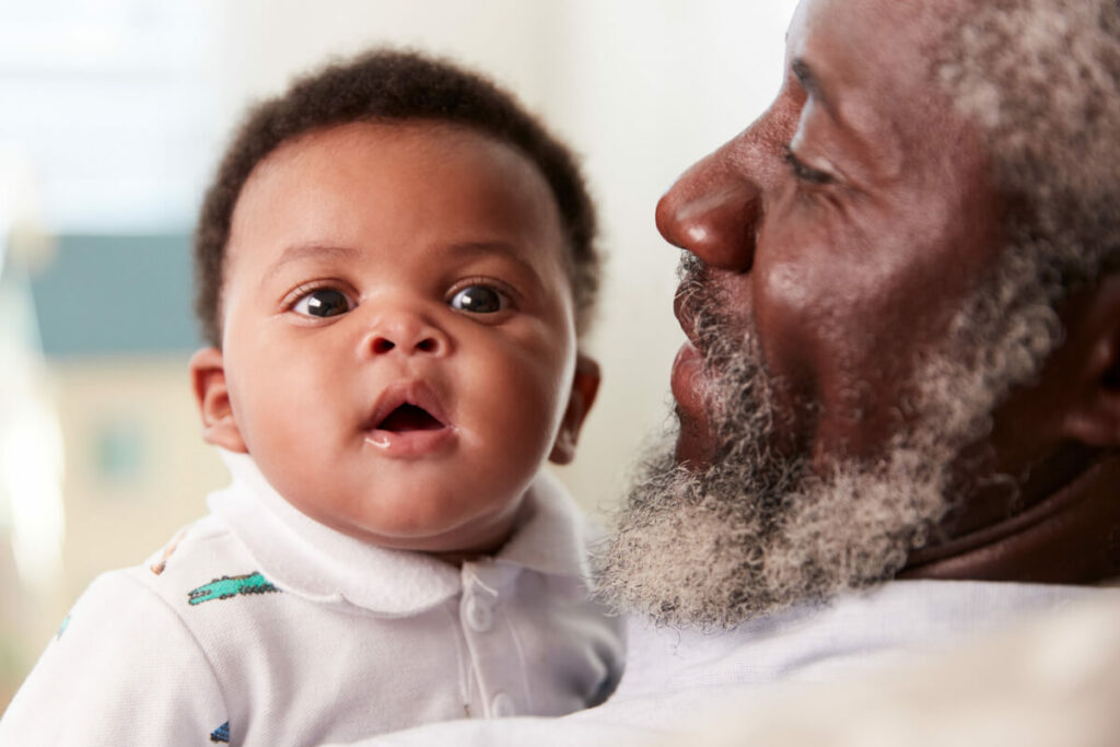 older man holding baby