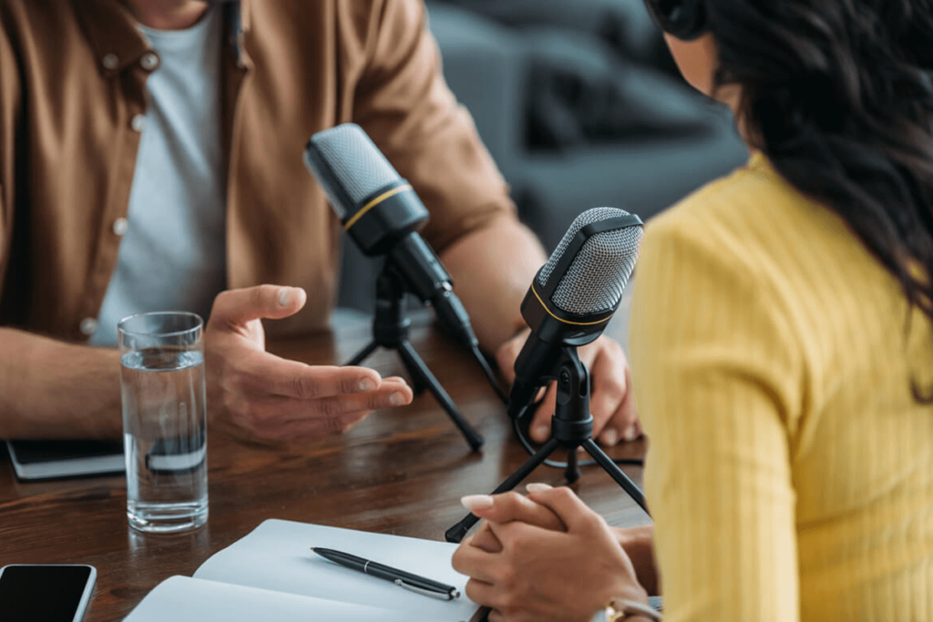 two people recording a podcast