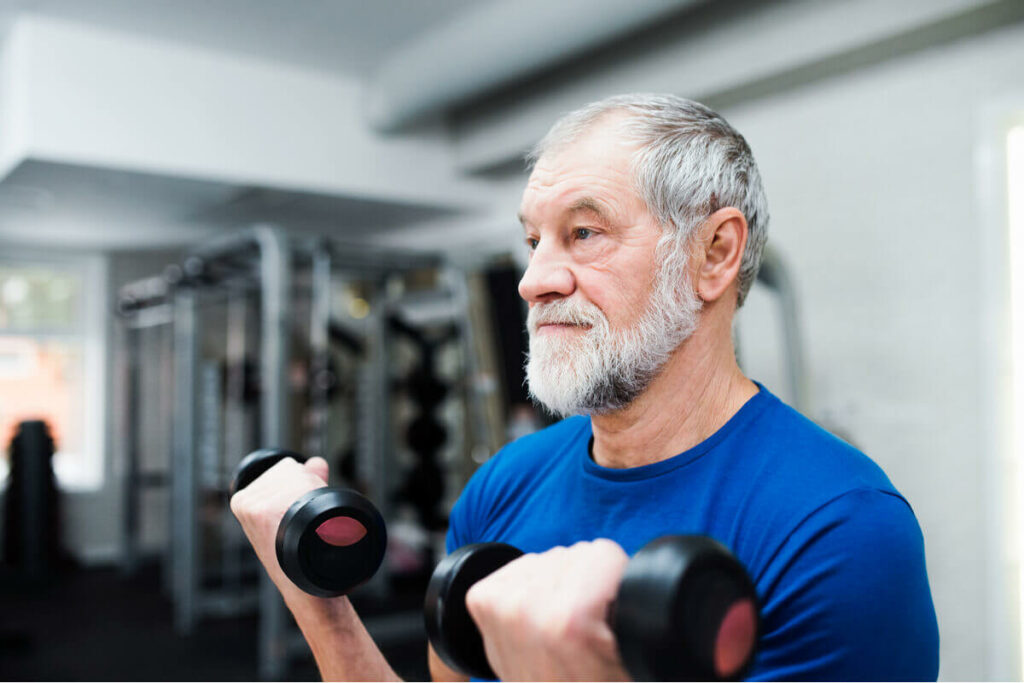 elderly man lifting weights