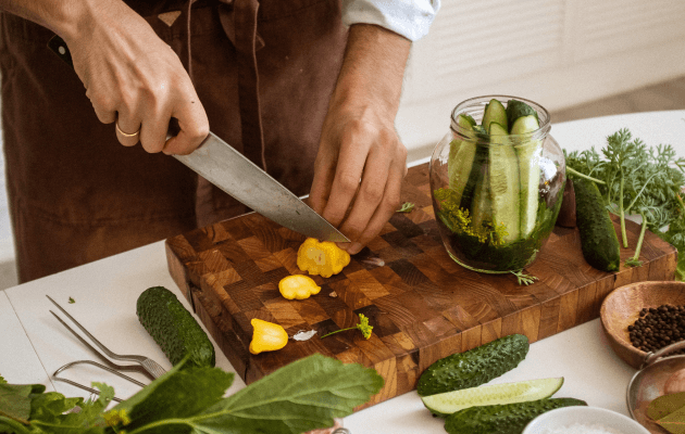 person chopping vegetables for pickling