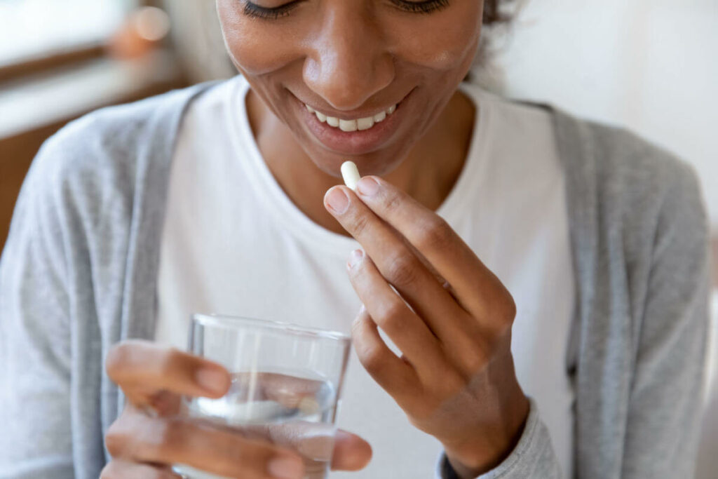 woman taking a supplement