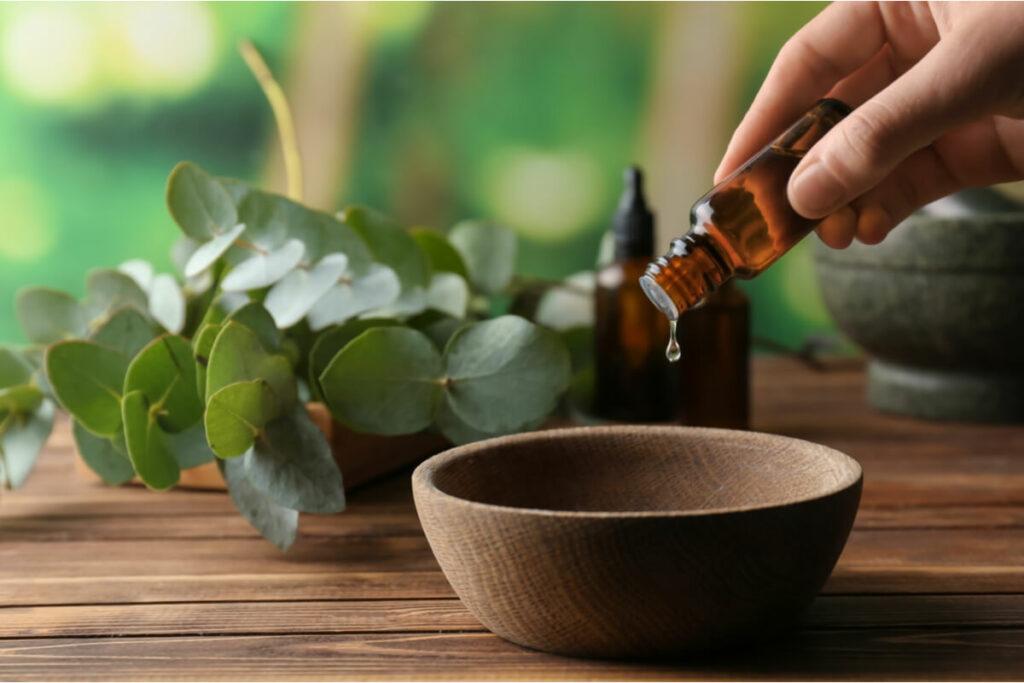 essential oils being poured into a bowl