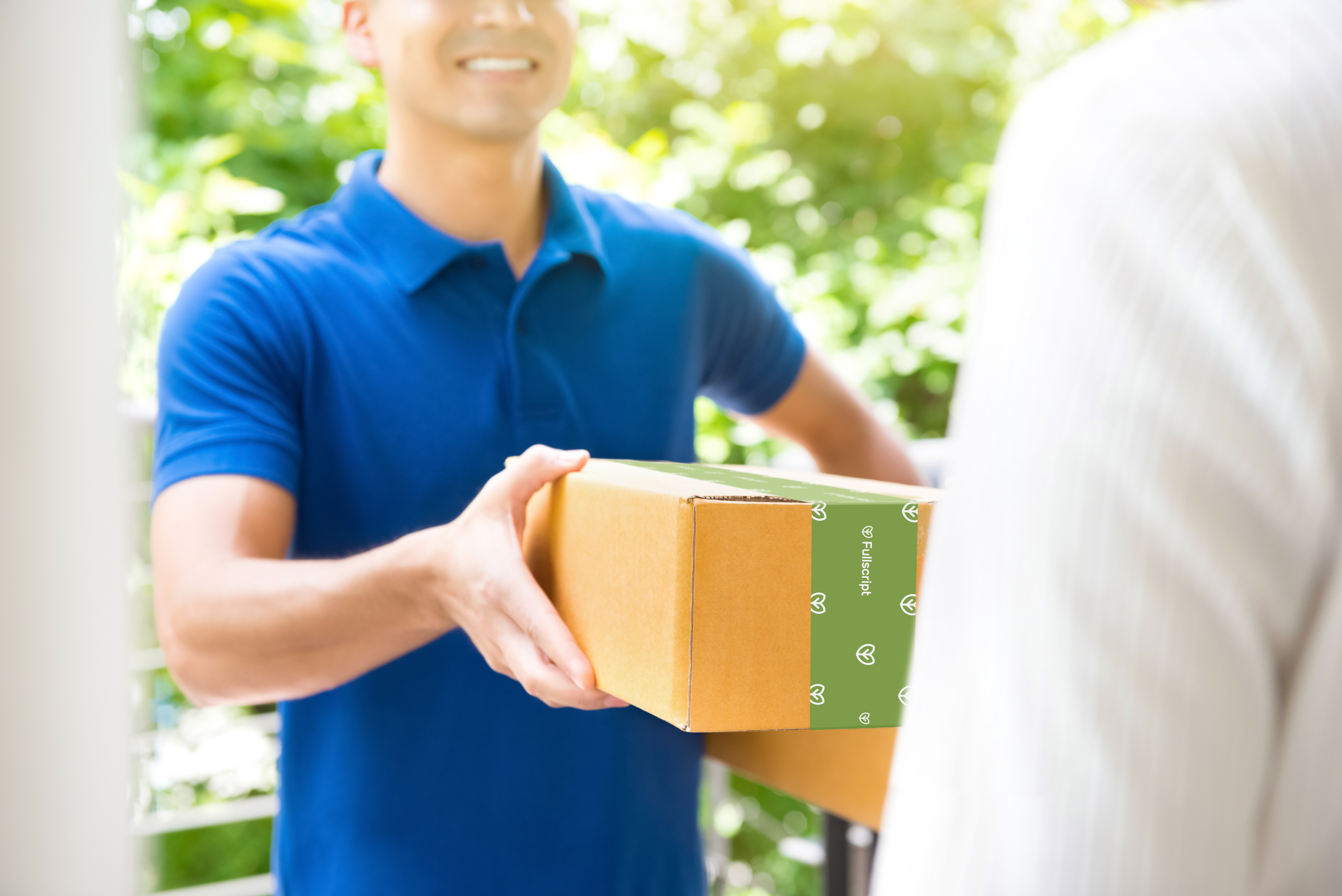 Delivery person handing a Fullscript package to a person