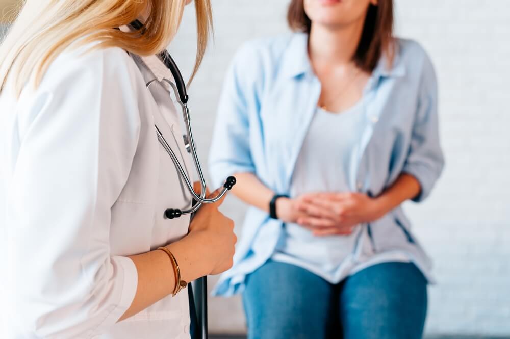 woman at her doctor's office to discuss her SIBO symptoms