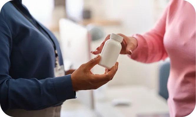 Practitioner giving a patient a supplement