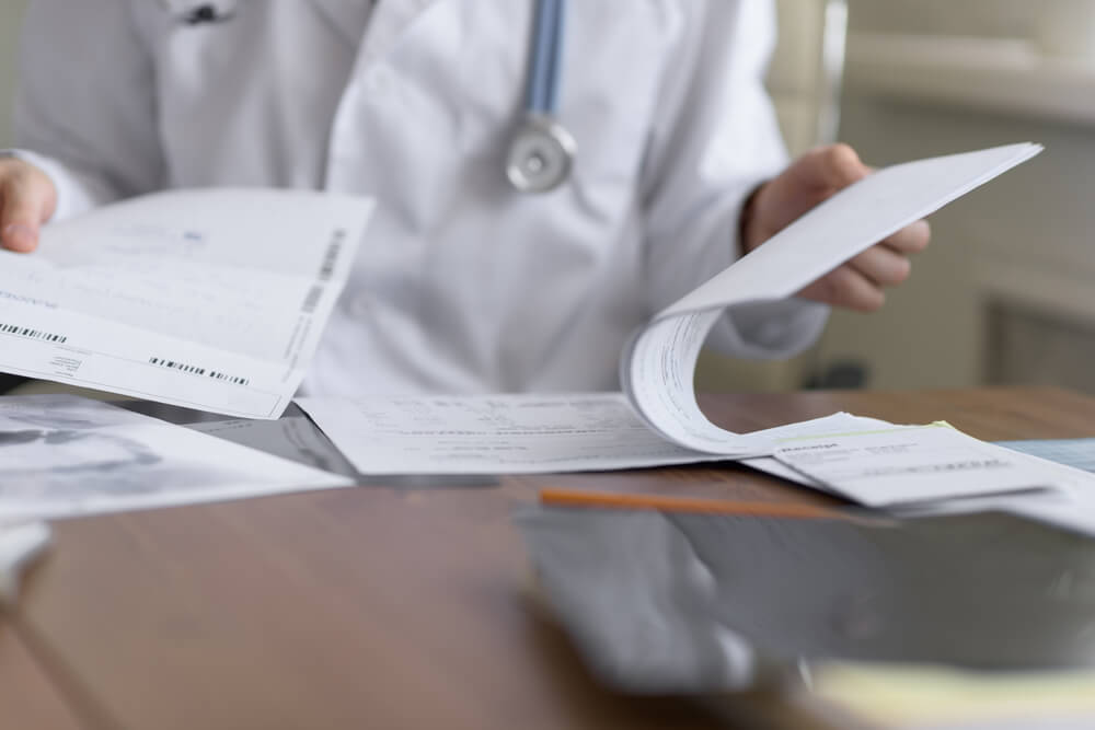 practitioner sorting through medical documents