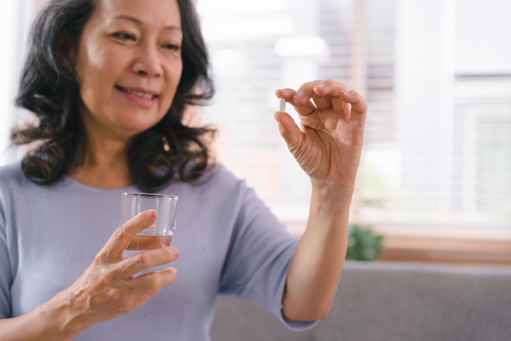 woman taking an akkermansia supplement