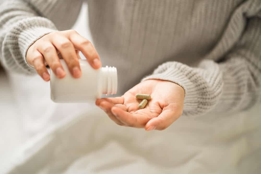 person taking glp-1 supplements for weight loss