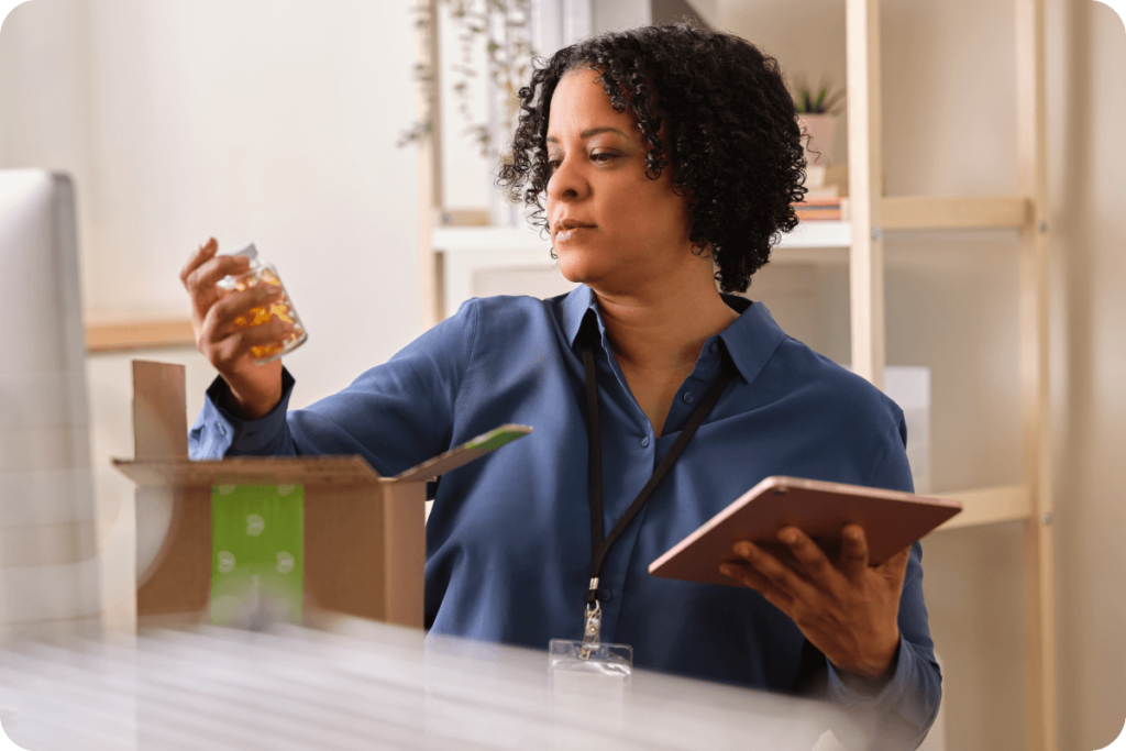 woman looking at bottle of supplements