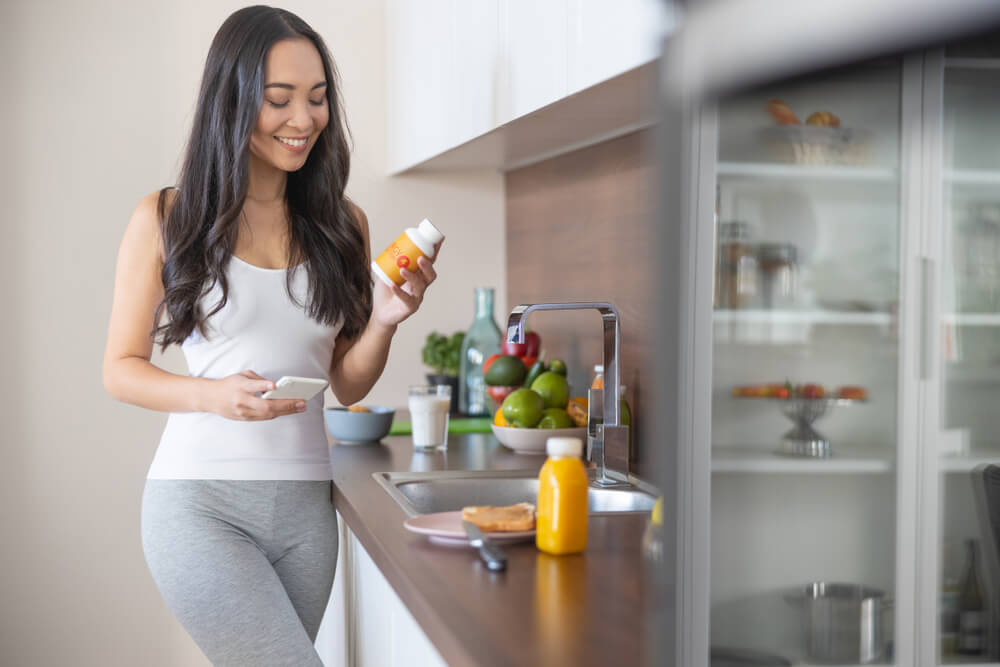 woman reading a supplement label