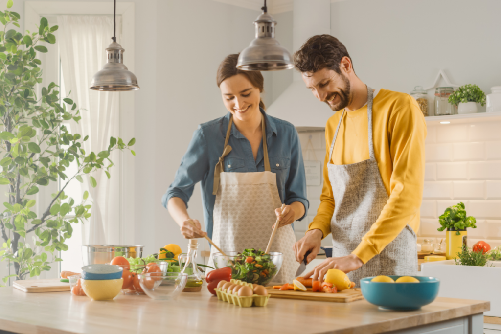 two people preparing fruits and vegetables