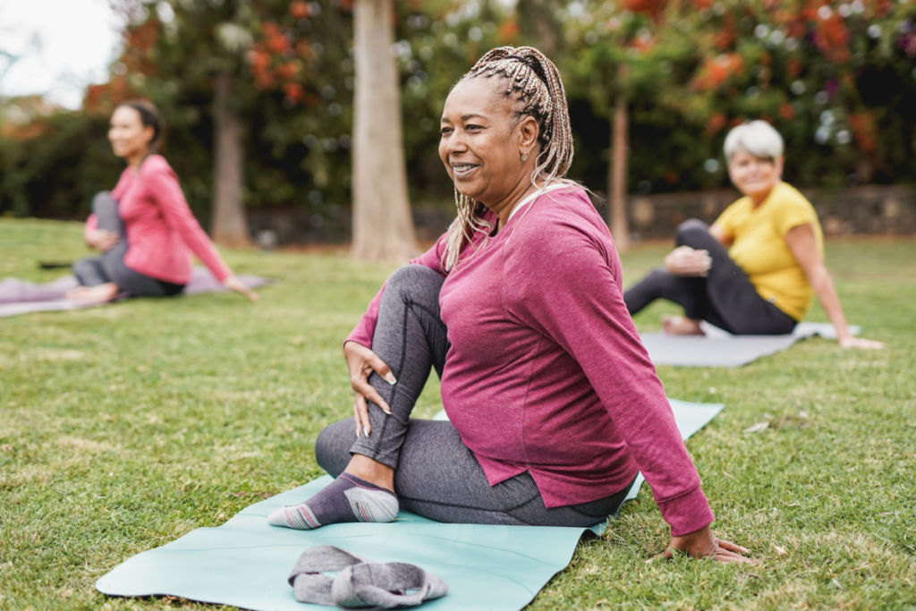 3 people doing yoga in the grass
