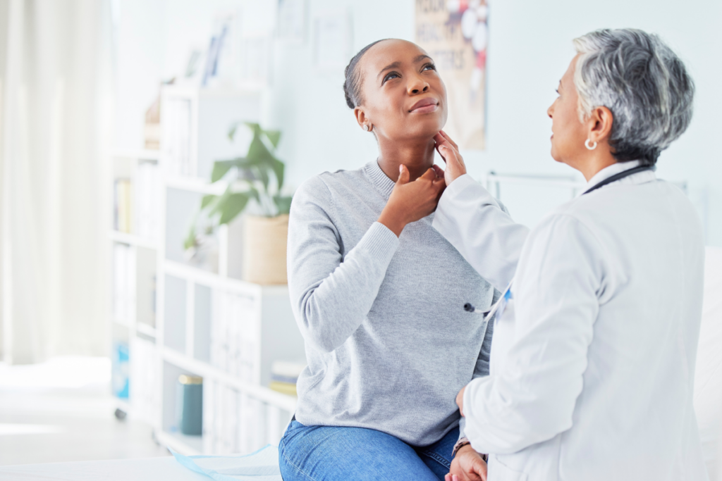 healthcare provider doing a physical examination to evaluate thyroid health