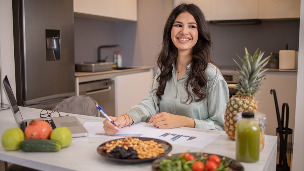 A woman is sitting at a table enjoying a meal. 